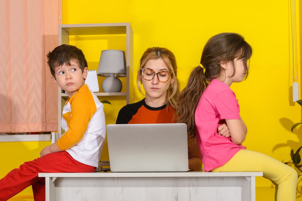 Mom bothered by Kids on her Desk