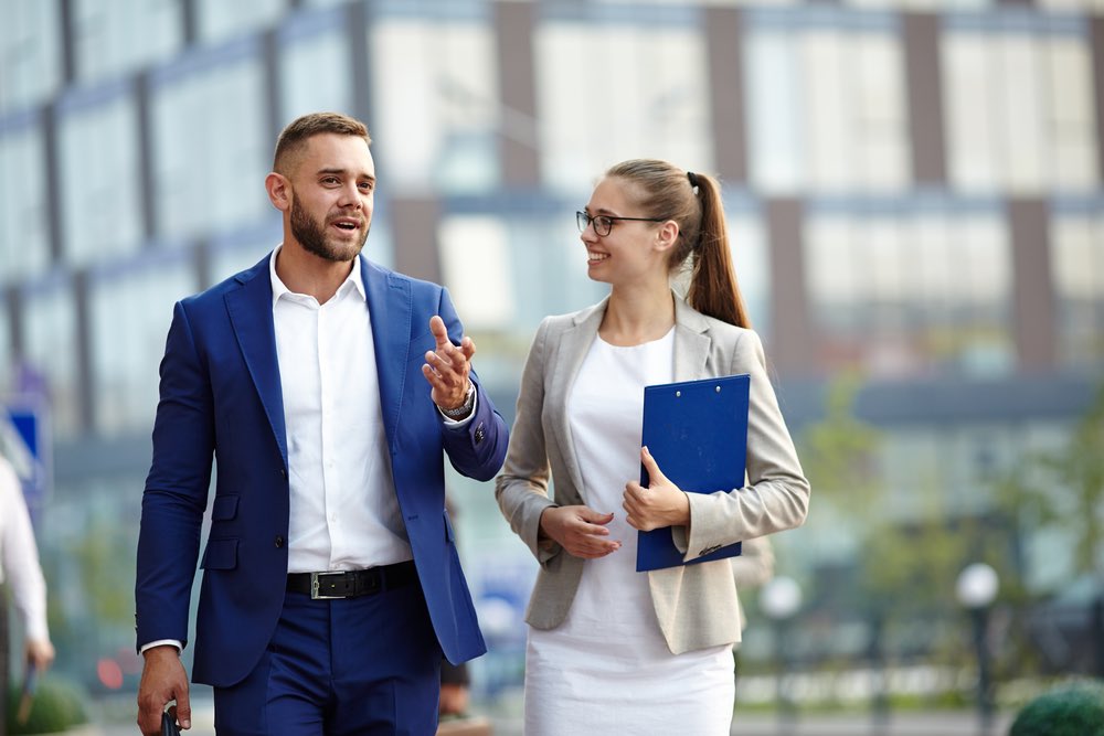 Young Male and Female Businessmen Communicating Smiling