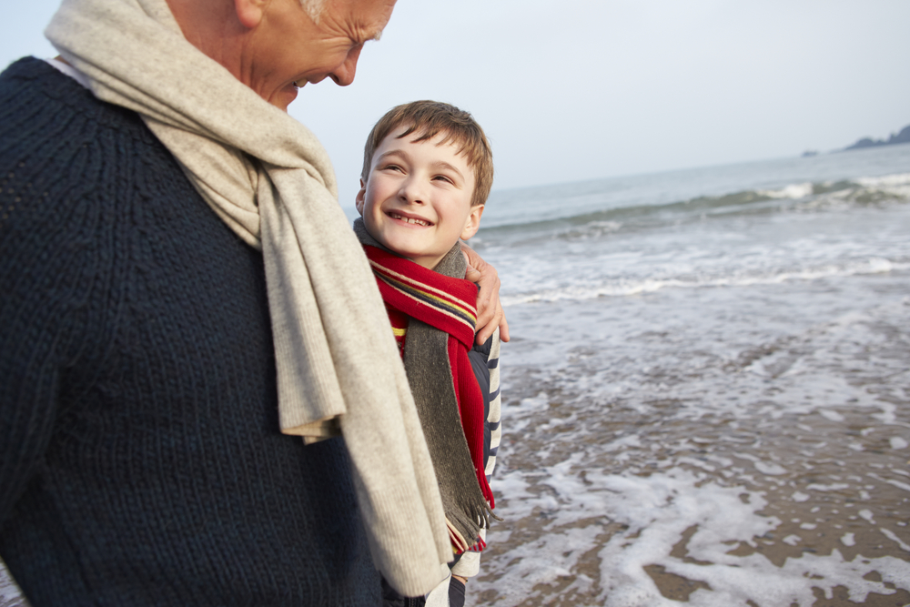 Grandfather and Grandson on winter beach Grandfather and Grandson walking on winter beach