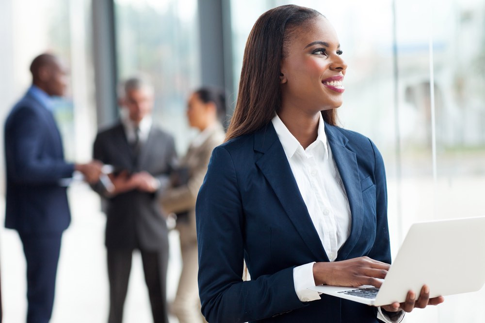 Woman and Laptop in Office Looking Out