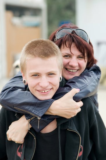 Mom hugging teenage boy