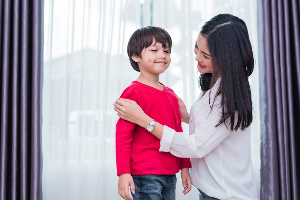 Mom Helping Son Get Dressed