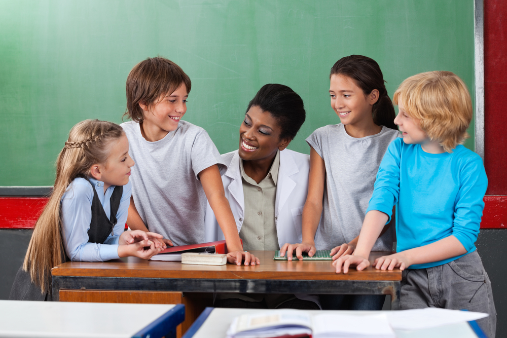 Students and Teacher smiling 