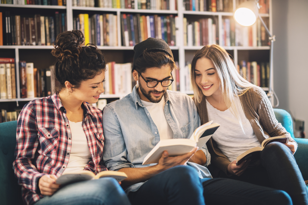 Team of Students Studying on a Bench in Library