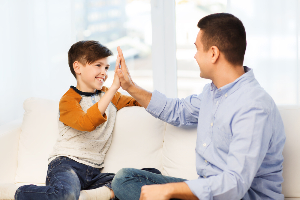 Father and Son High Fiving