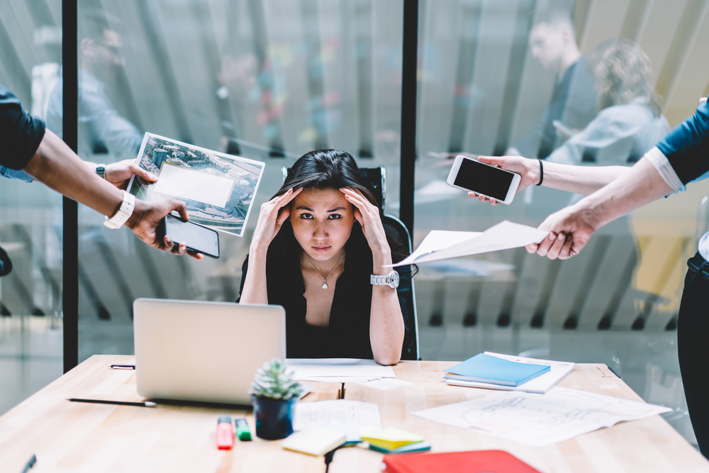 Woman Stressed at Work from Multi-Tasking