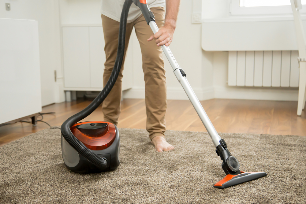 Young Adult Vacuuming Young Adult Vacuuming