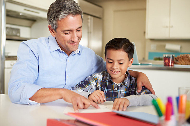 Father and Young Son Doing Homework